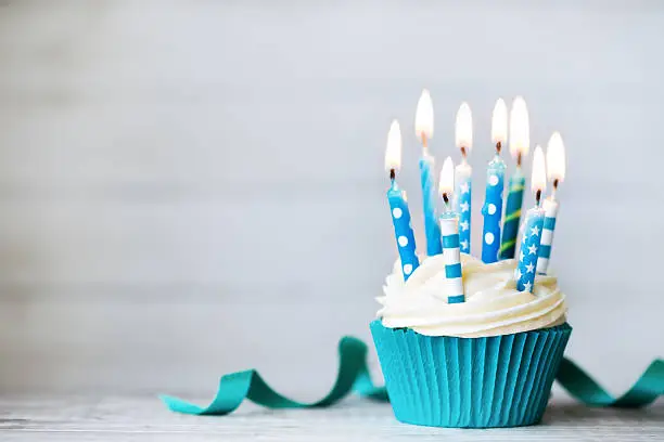 Cupcake with blue birthday candles