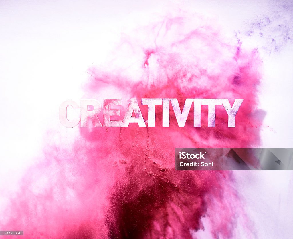 Red Colored Creativity blast 3D printed words: creativity - red powder thrown on the word hanging in the air against the wall. Exploding Stock Photo