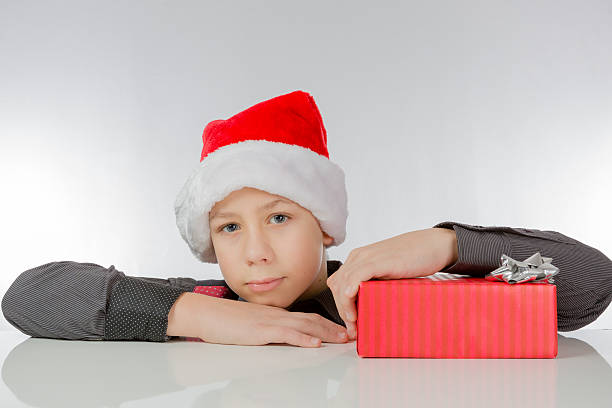 istock Boy looks happily, in his hand he holds a present 532182268