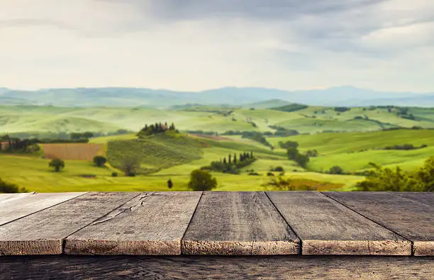 Empty wooden planks with Italian landscape on background. Ideal for product placement