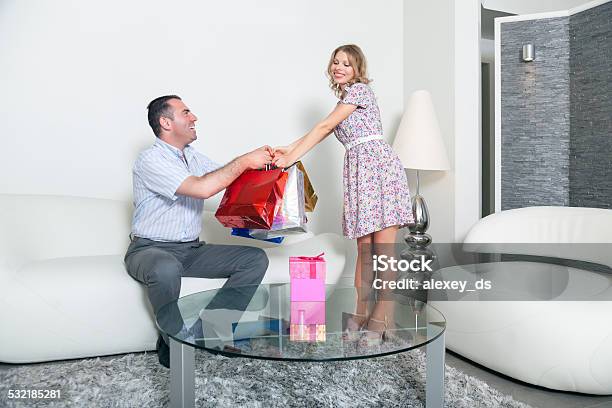 Husband Gives Packages With Gifts To Pleased Wife Stock Photo - Download Image Now - 2015, Adult, Affectionate