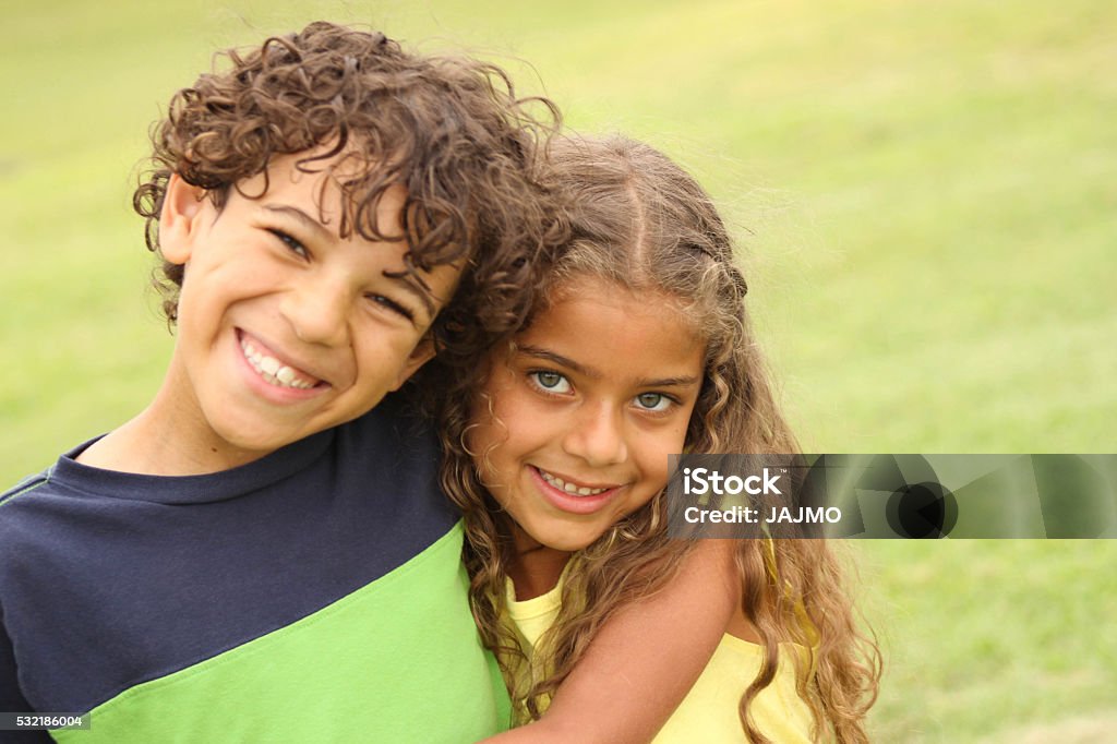 Brother and Sister Smiling Brother and Sister Smiling at the Park Brother Stock Photo