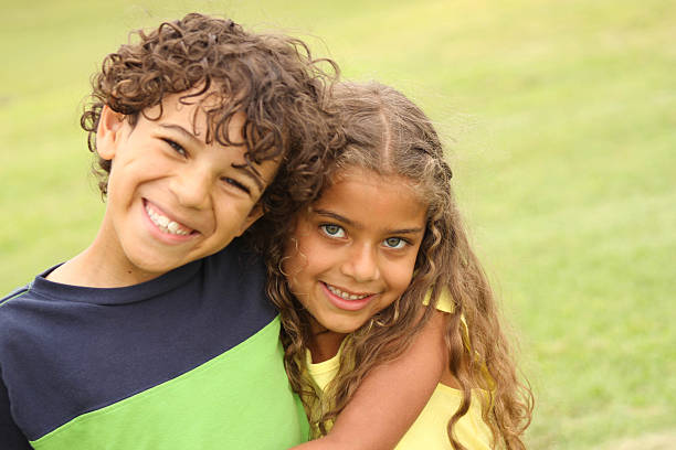 Brother and Sister Smiling Brother and Sister Smiling at the Park brother stock pictures, royalty-free photos & images