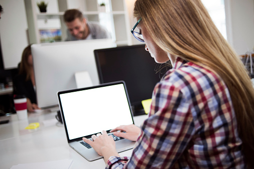 Young woman working on laptop in the office