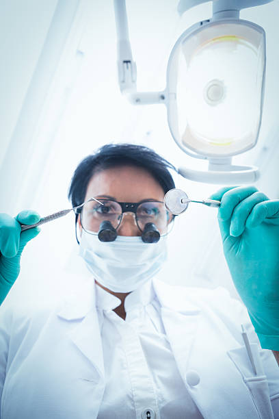 istock Female dentist in surgical mask holding dental tools 532186757