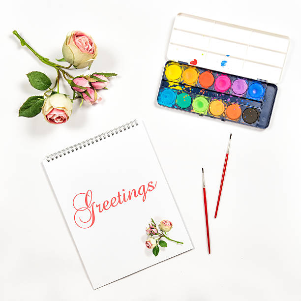 istock Sketchbook watercolor brushes paper flowers greetings 532186944
