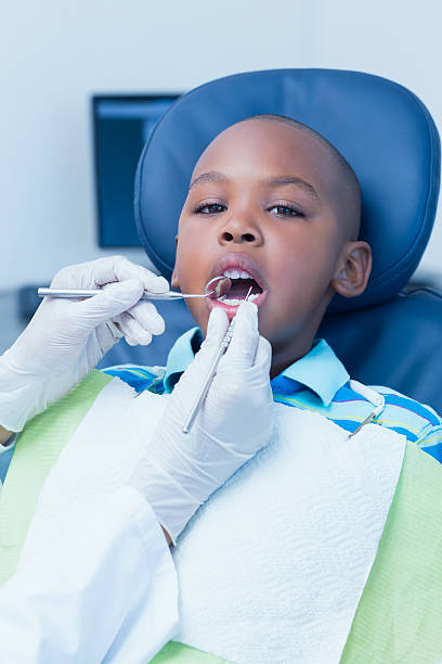 istock Close up of boy having his teeth examined 532186989