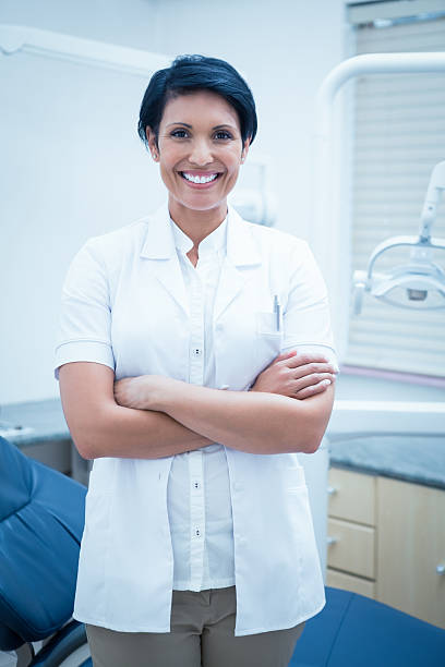 istock Smiling female dentist with arms crossed 532187183
