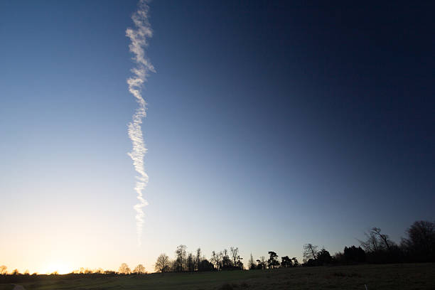 A vapour trail over Sevenoaks in England at sunrise, taken from Knole Park