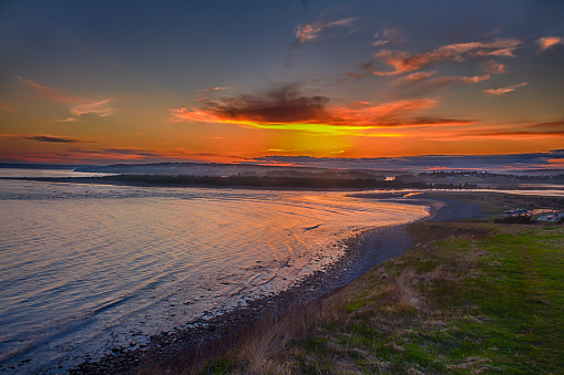 A beautiful beach sunset in Halifax, Nova Scotia, Canada.  Warm and vibrant green colours