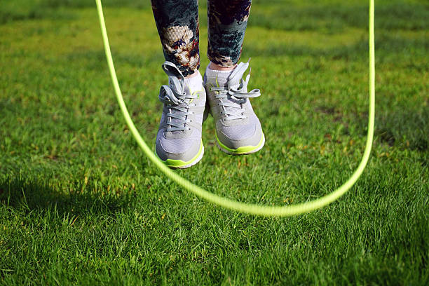 istock woman jumping on a skipping rope in park 532189168