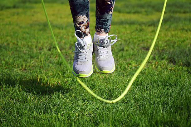 istock woman jumping on a skipping rope in park 532189212