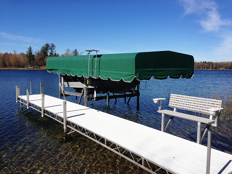An aluminum dock and covered boat lift on northern Minnesota lake.