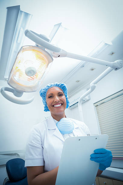 istock Smiling female dentist holding clipboard 532189505