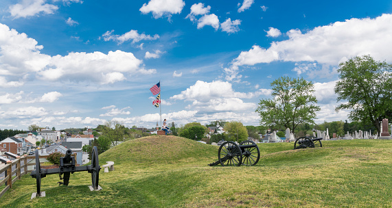 Doubleday Hill - Civil War's national monument, Williamsport, Maryland, USA. Cannons and cemetery at the hilltop. Two girls explore the historic place.
