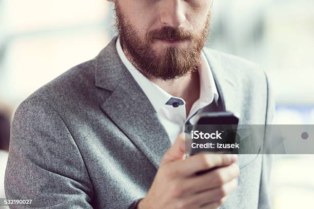Bearded Businessman Using Smart Phone Stock Photo - Download Image Now - 2015, Adult, Beard