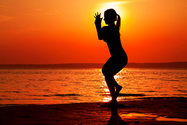 istock Young Woman Silhouette While Doing Yoga Exercise 532191446