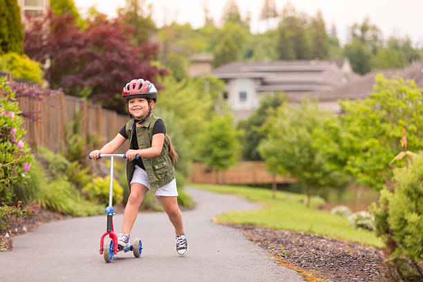 istock Gorgeous ethnic young girl on a scooter outdoors smiling 532192482