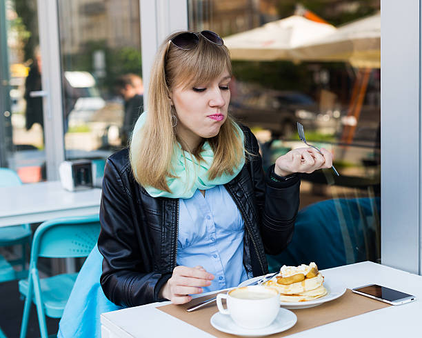 mujer joven hermosa de comer desayuno - business blurred motion text messaging defocused fotografías e imágenes de stock