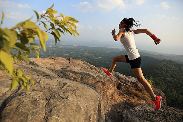 istock young woman trail runner running on mountain peak 532194114