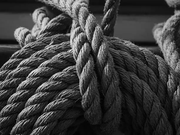 black and white of lines or ropes on a traditional sailboat
