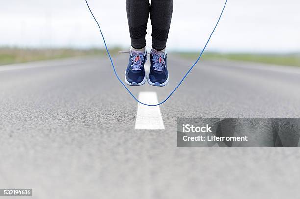 Woman Doing Jump Roping On A Sports Field Stock Photo - Download Image Now - 30-34 Years, 30-39 Years, Adult