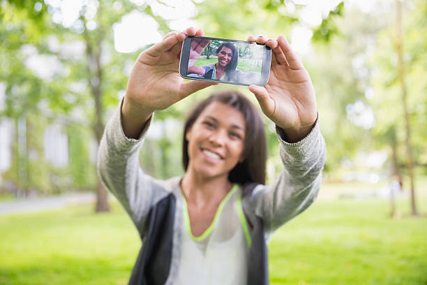istock Pretty brunette taking a selfie in park 532202475