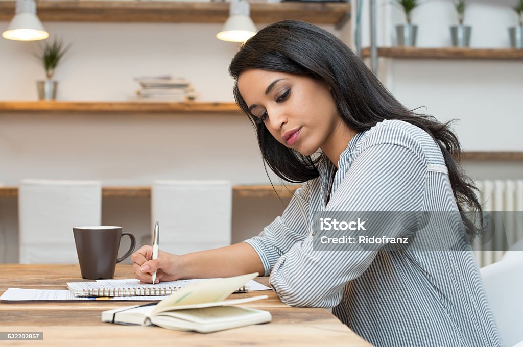 Student studying for the exam Portrait of young african woman studying at the library General Certificate of Secondary Education Stock Photo