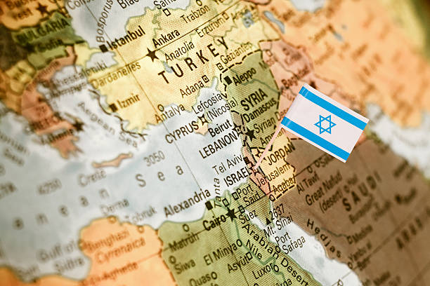 map with miniature flag of Israel .Selective focus on Israeli Flag.  Detail Globe Backlit lighting