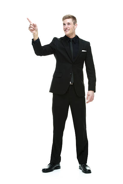 istock Smiling businessman pointing away 532205473