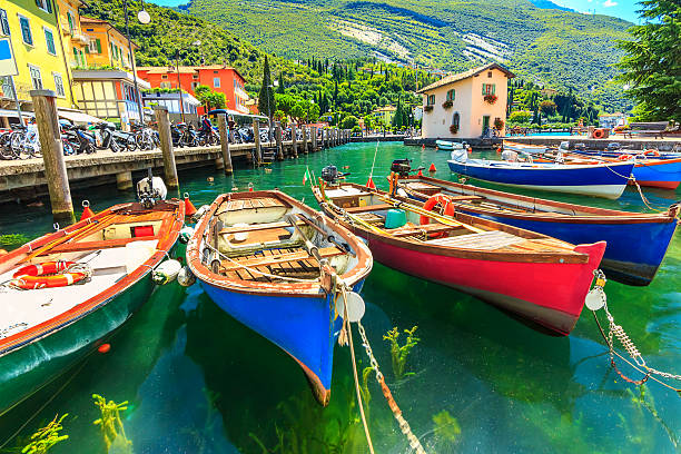 Colorful boats on the lake,Garda lake,Torbole,Italy,Europe Summer landscape and wooden boats,Lake Garda,Torbole town,Italy,Europe lake garda photos stock pictures, royalty-free photos & images