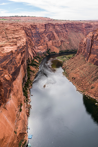 United States. Arizona. Coconino County. The desert near Lake Powell. Lake Powell is a reservoir on the Colorado River, between Utah and Arizona. It is a vacation spot visited by two million people every year. It lies on an area of 161,390 acres (65,310 ha) and has 1960 miles (3161 km) of shoreline (more than the entire Pacific coast of USA). Because of its ecological effect on the Colorado River and on the environment, Lake Powell and its dam have inspired heavy controversy from environmentalists.