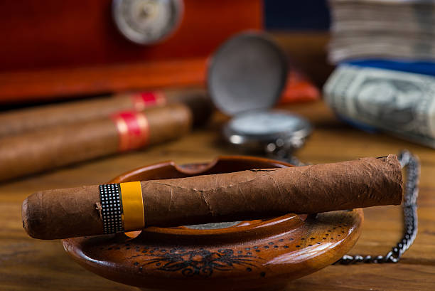 istock rich person or bussinesman desk with cuban cigar, bank notes 532208699