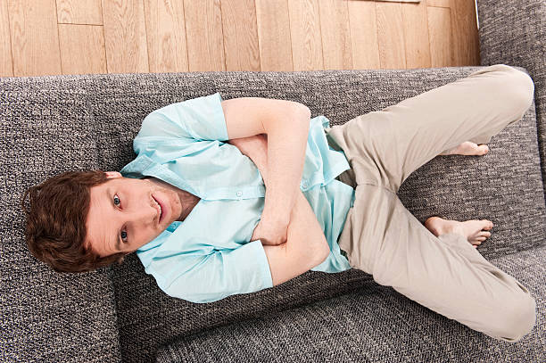 istock Germany, Hamburg, man resting on sofa smiling 532222051