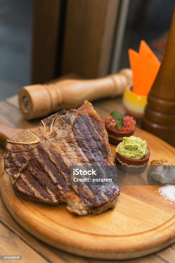 T-bone steak Grilled BBQ T-bone steak served on wooden plate 2015 Stock Photo