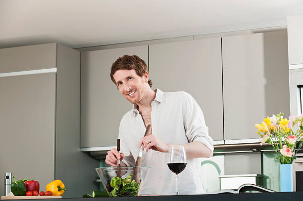 istock Germany, Hamburg, Man in kitchen preparing salad 532241863