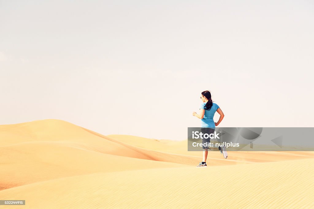 jogging in the desert a runner jogging through the desert. Dubai Stock Photo