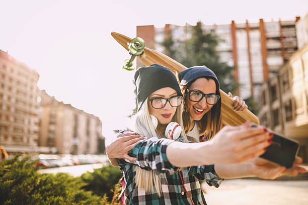 istock Hipster girlfriends taking a selfie in urban city 532249288
