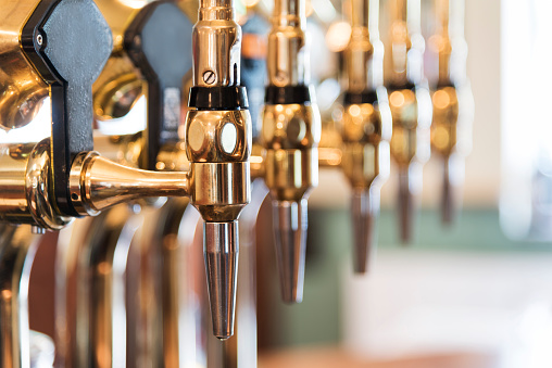 Beer taps in a bar.