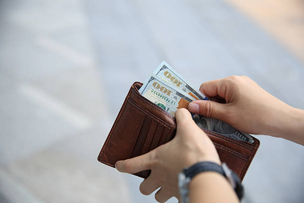 istock Hands taking  us dollars  out from wallet on the street 532250382