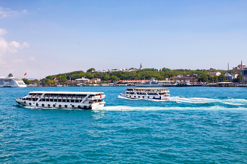 Tour boats passes in front of Topkapi palace in Istanbul