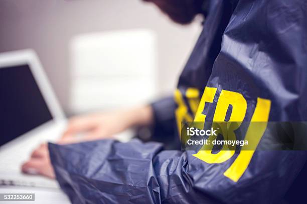 Policeman Using Laptop In Office Stock Photo - Download Image Now - FBI, FBI Building, Computer Crime
