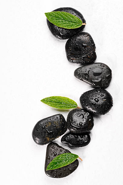 istock spa basalt stones and green leaves with water drops 532254600