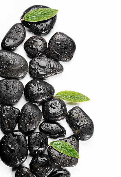istock spa basalt stones and green leaves with water drops 532254630