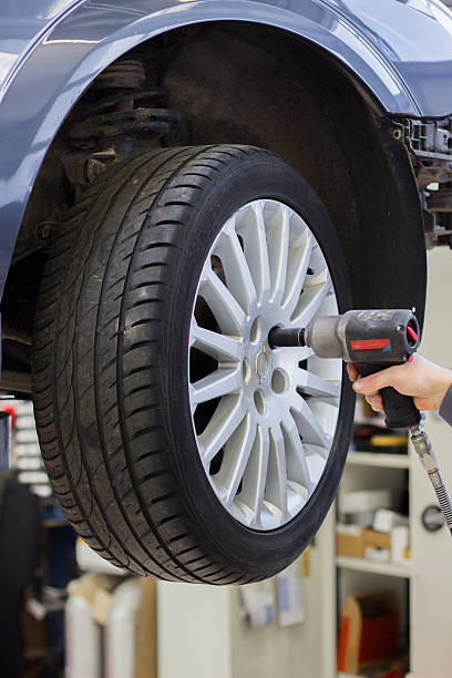 istock Mechanic changing wheel on car with a wrench 532256553
