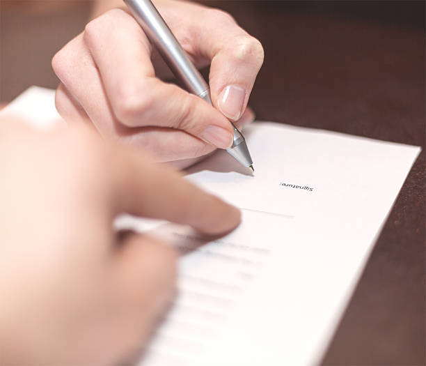 istock Hands of two people signed the document. 532256585