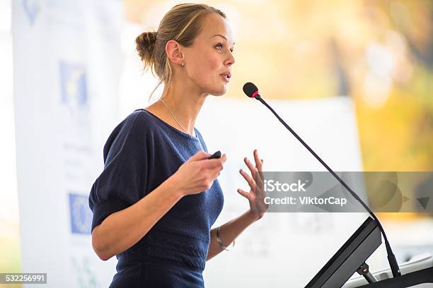 Pretty Young Business Woman Giving A Presentation Stock Photo - Download Image Now - Public Speaker, Speech, Women