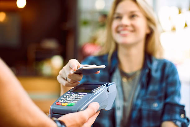 istock Happy woman using mobile payment at coffee shop 532260190