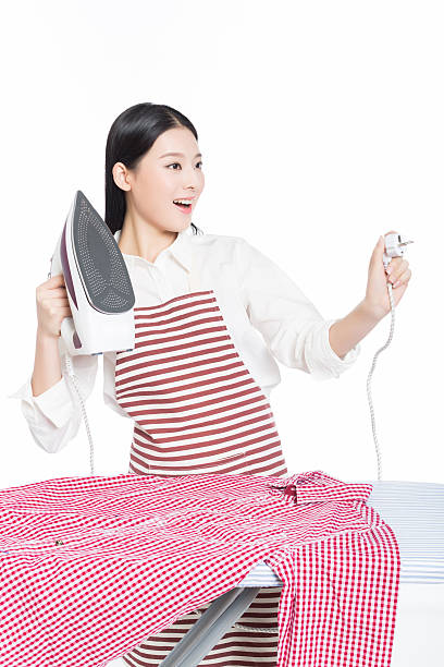 istock young housewife ironing 532260195