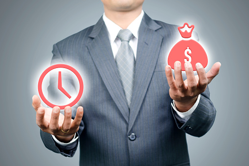 Young man measuring between time and money